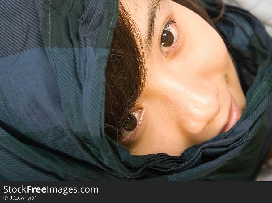 A young asian girl with a blue scarves. A young asian girl with a blue scarves