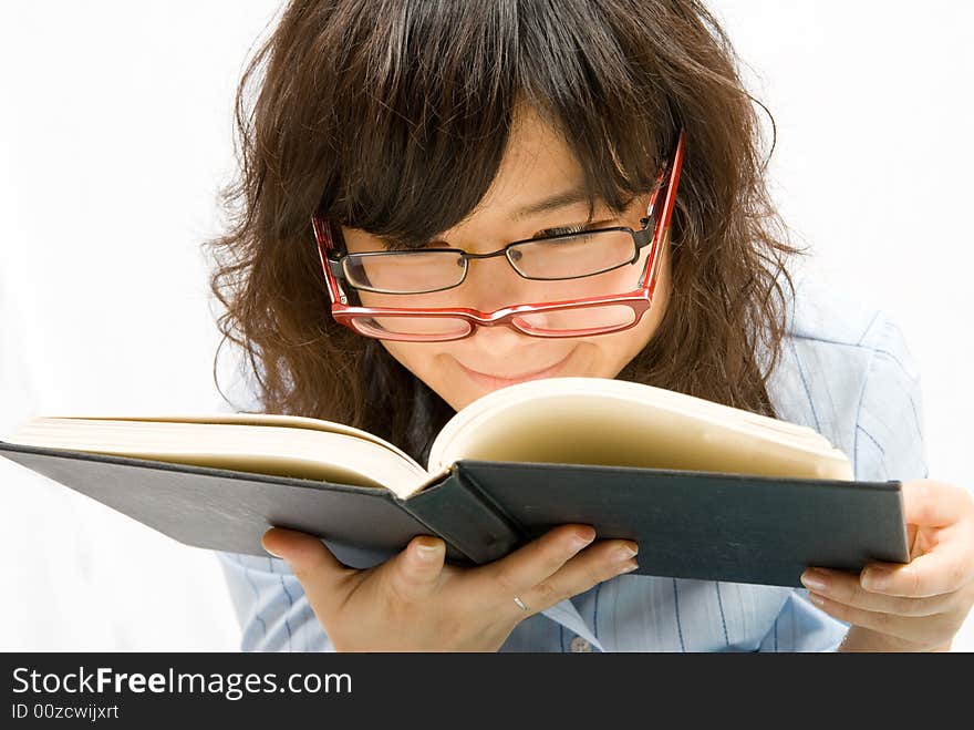 A cute office lady with two different color glass is reading a book with black cover. A cute office lady with two different color glass is reading a book with black cover.