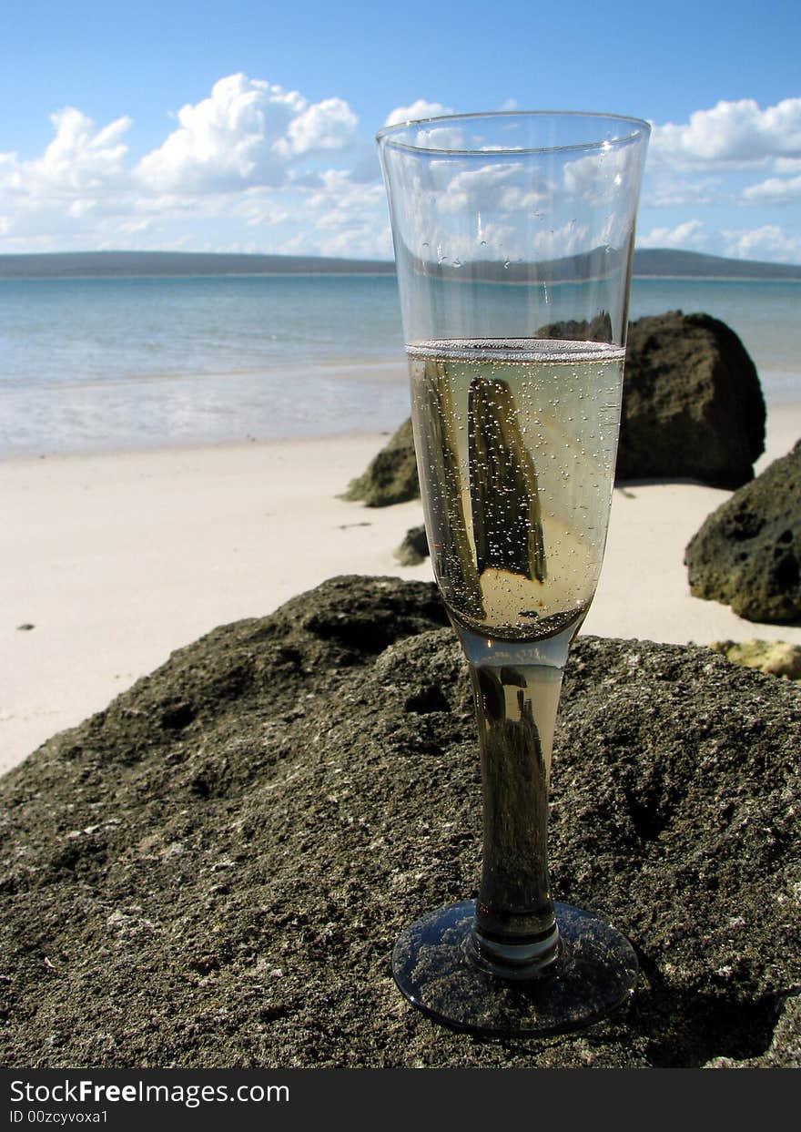 Champagne glass on a rock at the beach. Champagne glass on a rock at the beach