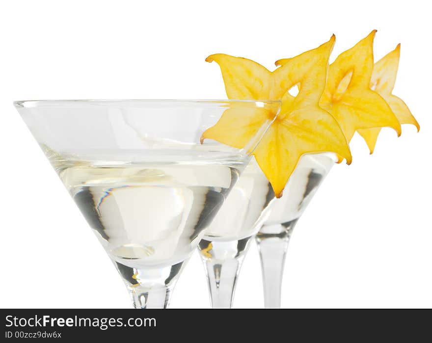 Glass of martini and slice of carambola on a white background. Glass of martini and slice of carambola on a white background