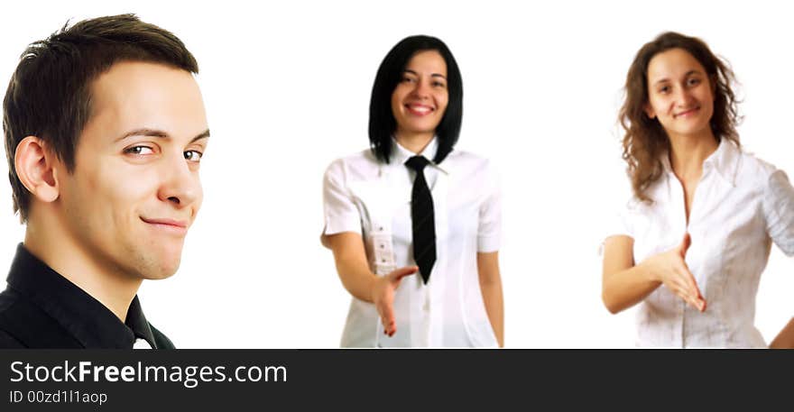 Two young pretty businesswomen are smiling and they are holding their hands out for handshaking. In front of them there is their boss who is smiling. Two young pretty businesswomen are smiling and they are holding their hands out for handshaking. In front of them there is their boss who is smiling.