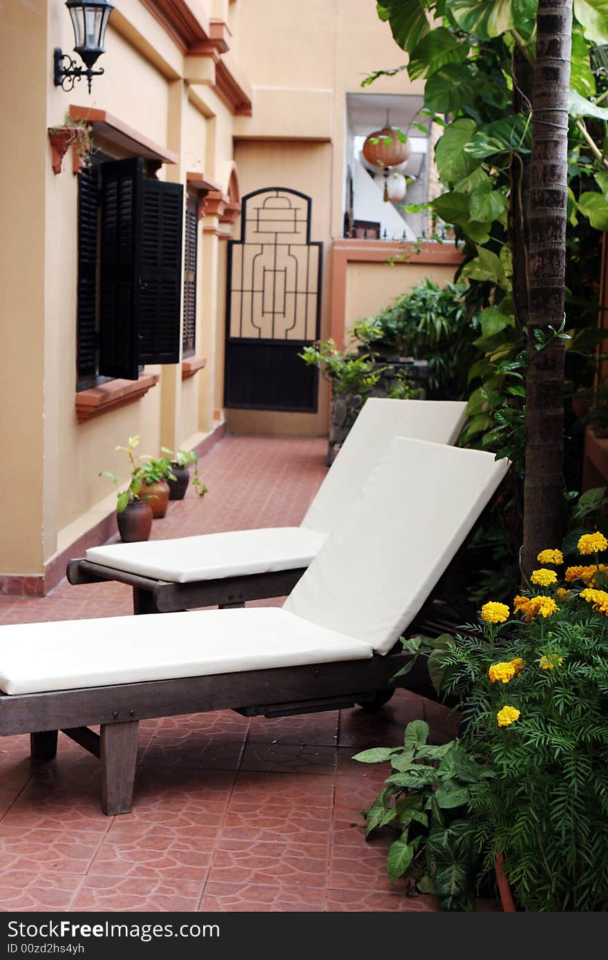 Deck chairs in a pretty outdoor seating area for summer.