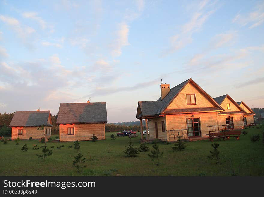 Group of small houses in red sunshine light.