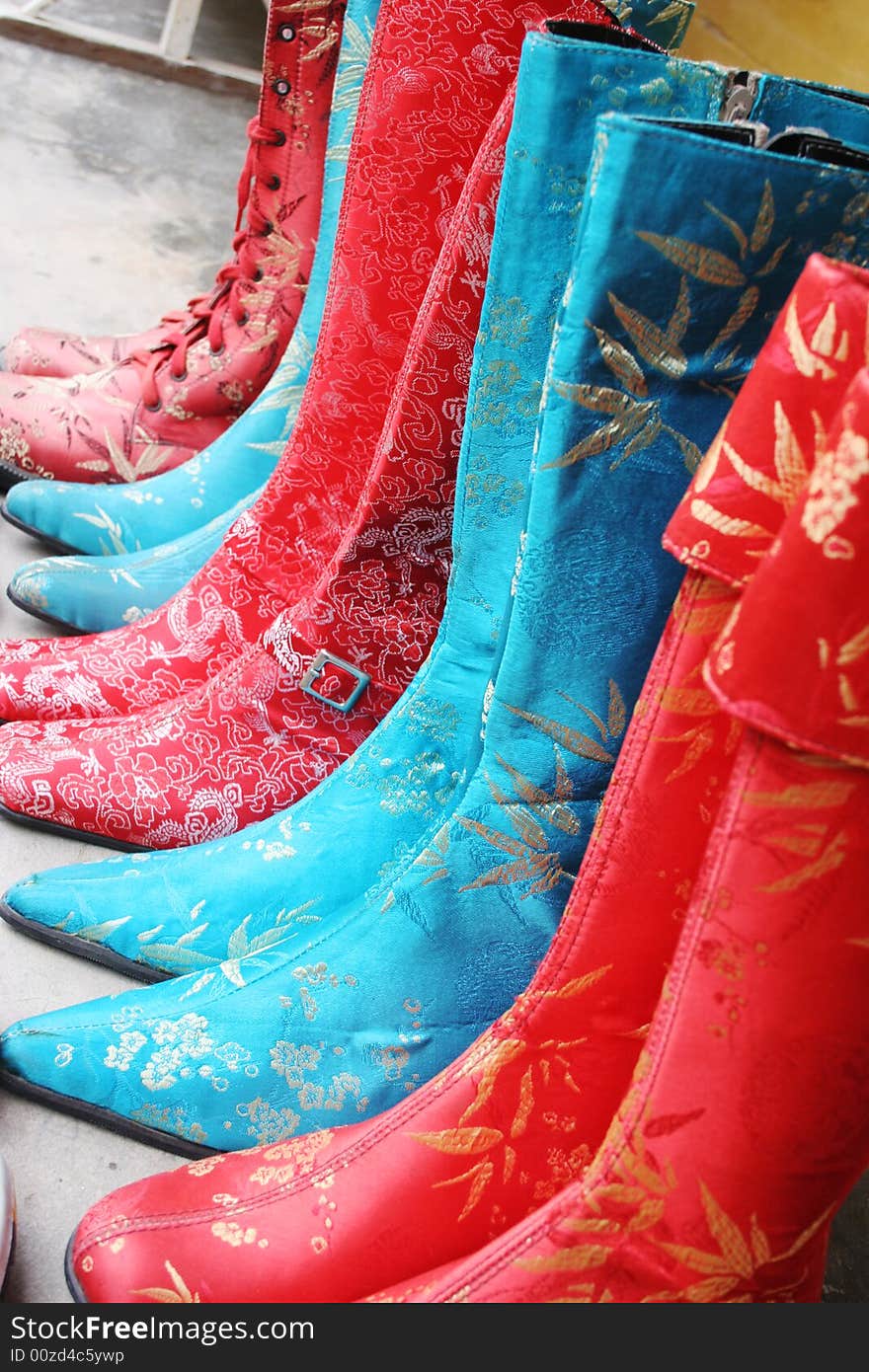 Handmade silk boots on display at a shop in Hoi An, Vietnam - travel and tourism. Handmade silk boots on display at a shop in Hoi An, Vietnam - travel and tourism.