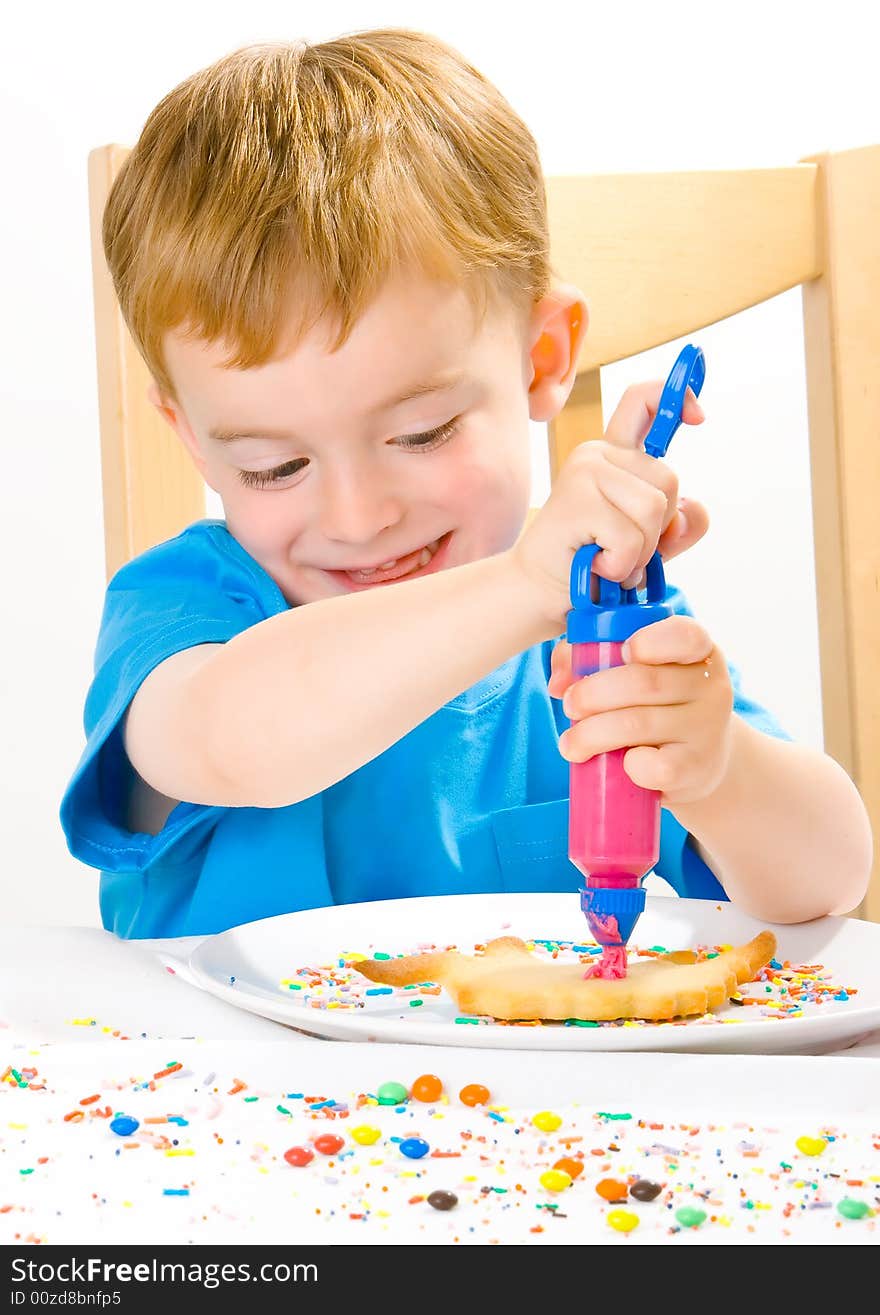 Boy Decorating Baked Biscuits