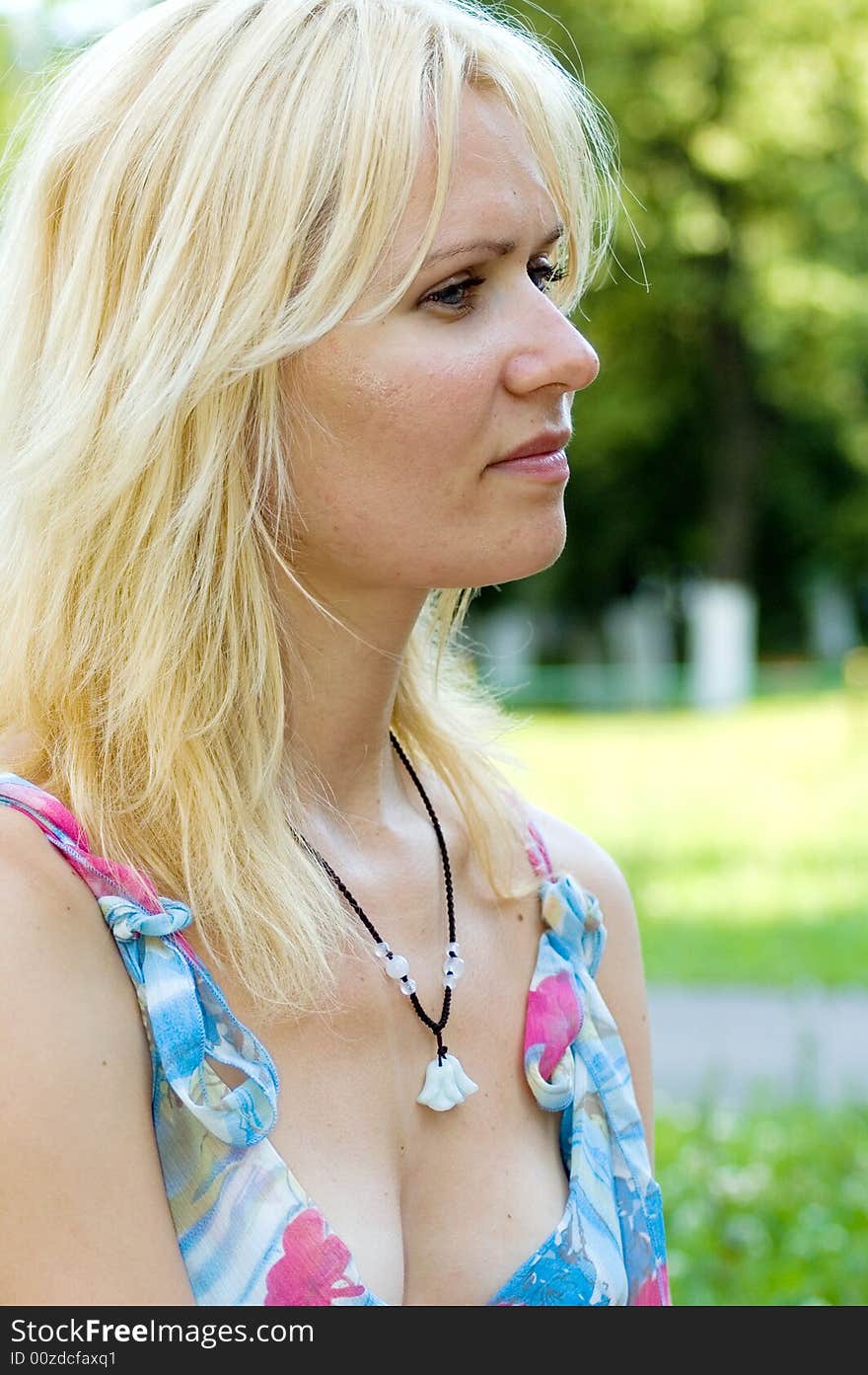 Beautiful blond young girl in a park. Beautiful blond young girl in a park