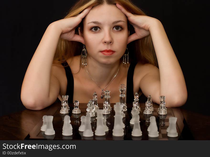 Portrait of beautiful young woman with chess