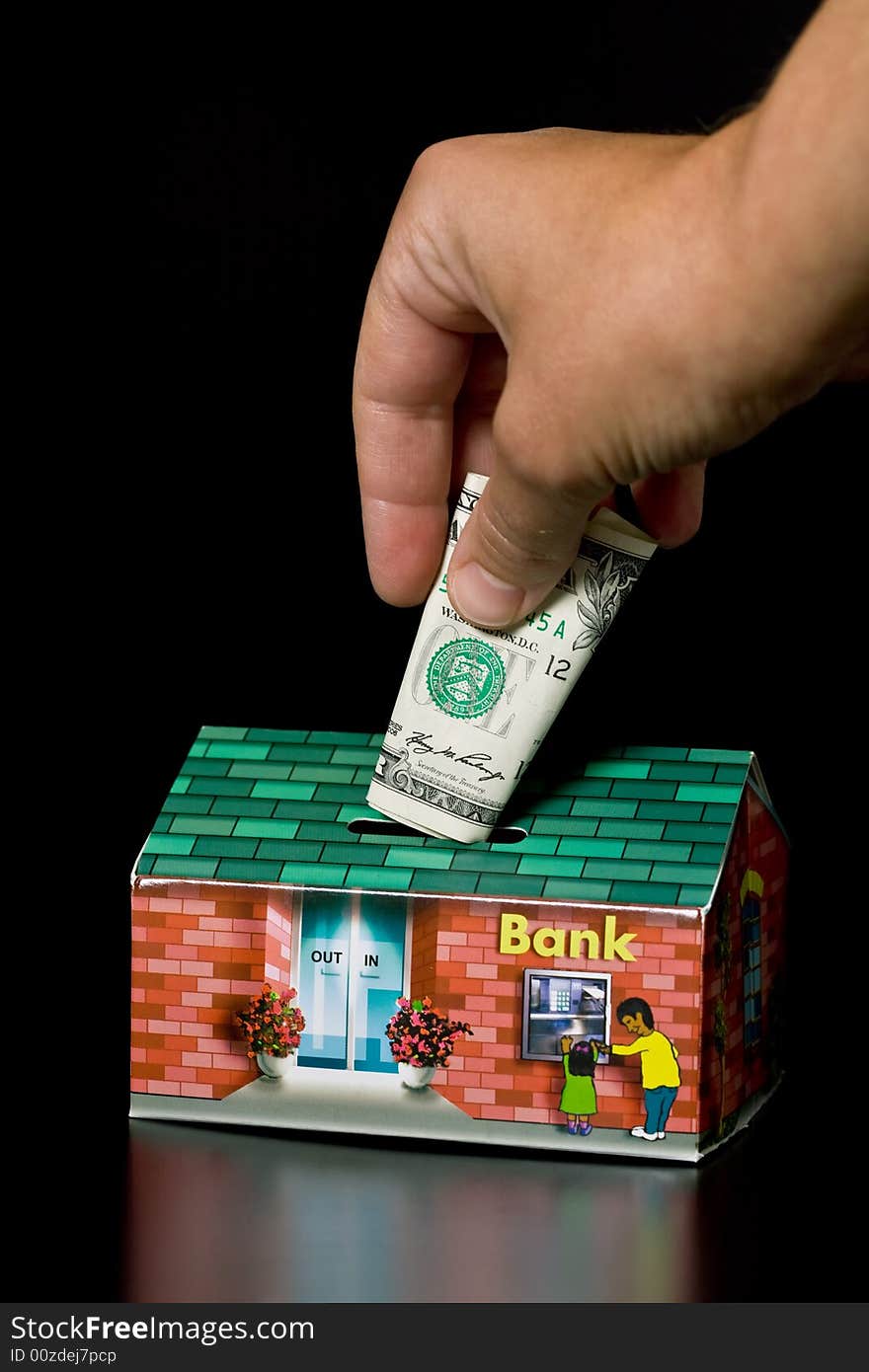 Dollar bills and cardboard bank box on black background