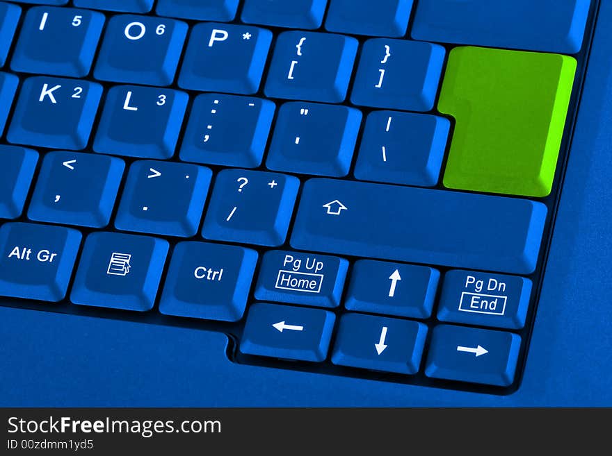 Blue keyboard with green blank button. Blue keyboard with green blank button