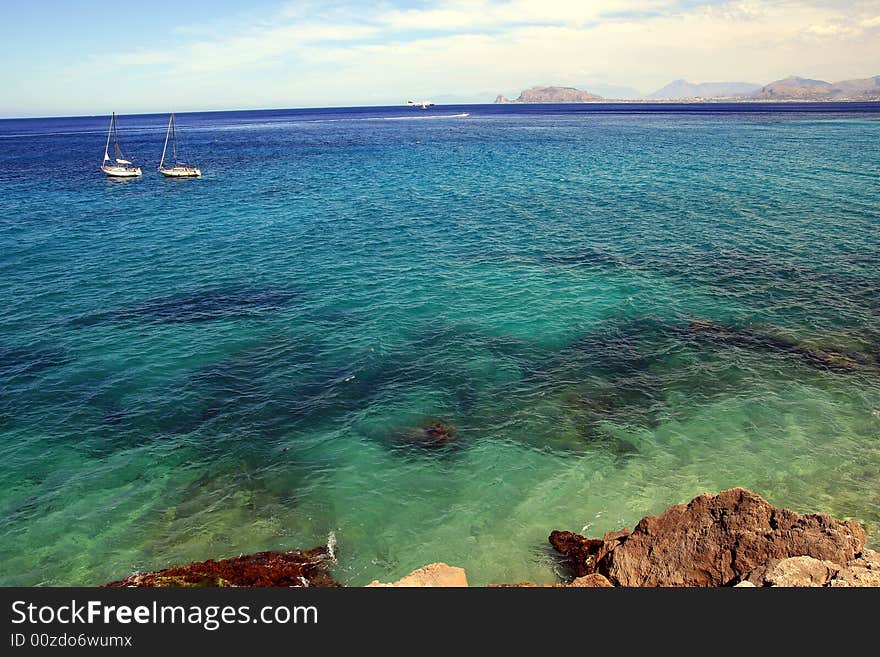 Seascape of blue mediterranean sea and coast an boats, Coast and gulf of Palermo. Island of Sicily, Italy. Seascape of blue mediterranean sea and coast an boats, Coast and gulf of Palermo. Island of Sicily, Italy