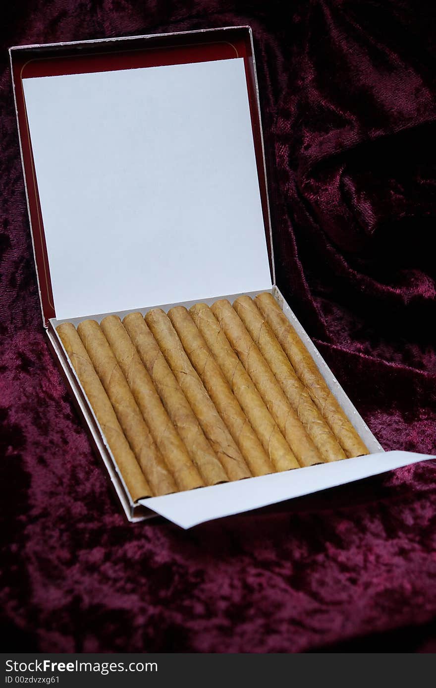 Luxury cigarillo package on crimson velvet