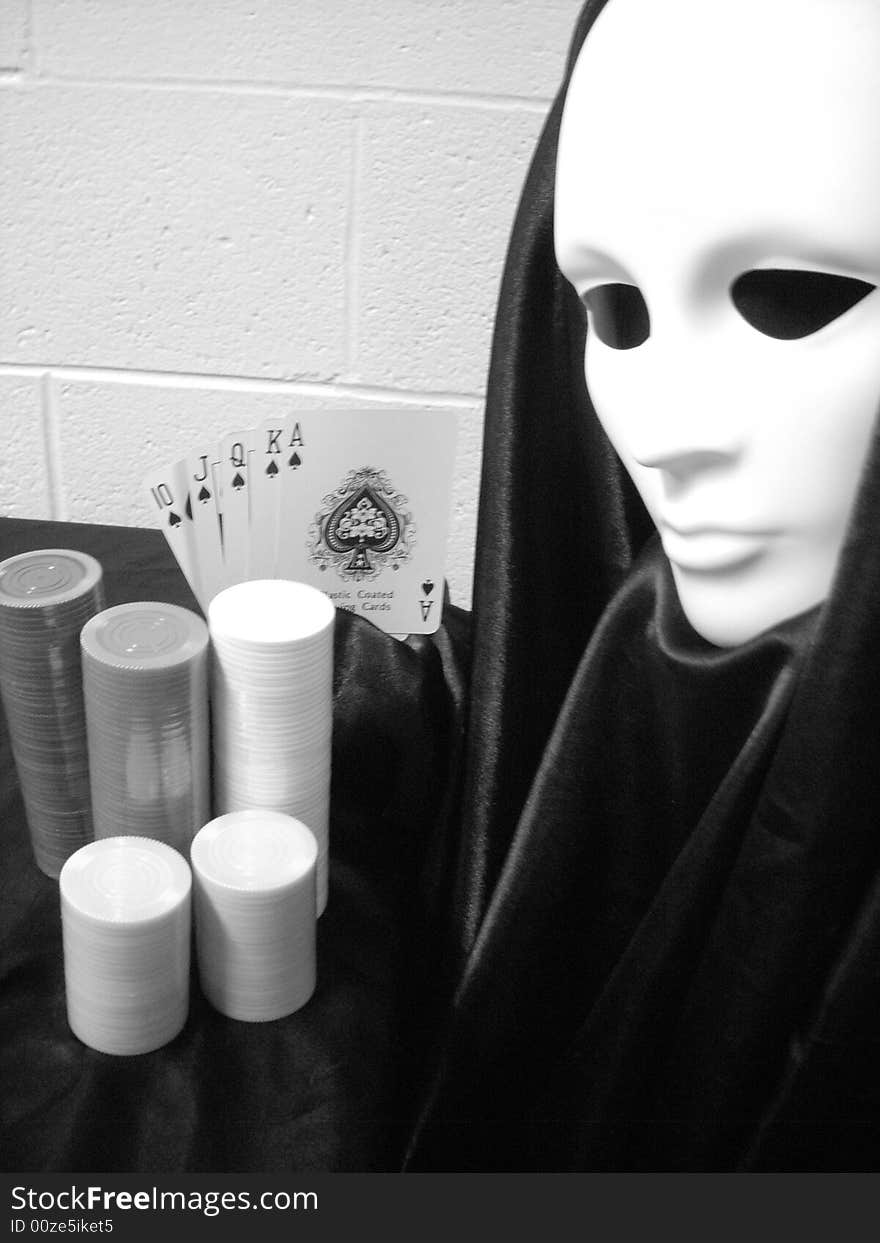 Black and white photo of masked image playing poker. Black and white photo of masked image playing poker.