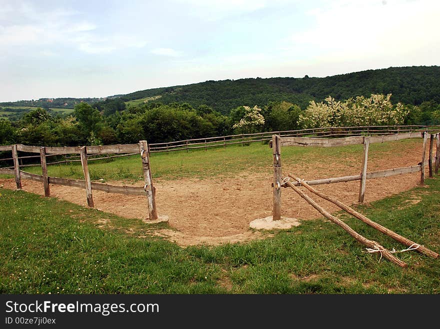 Opened fence no horse on green meadow. Opened fence no horse on green meadow