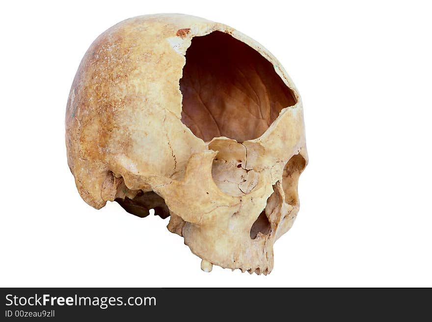 Old broken skull against white background