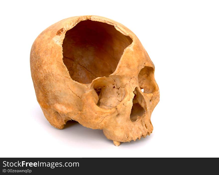 Old broken skull against white background