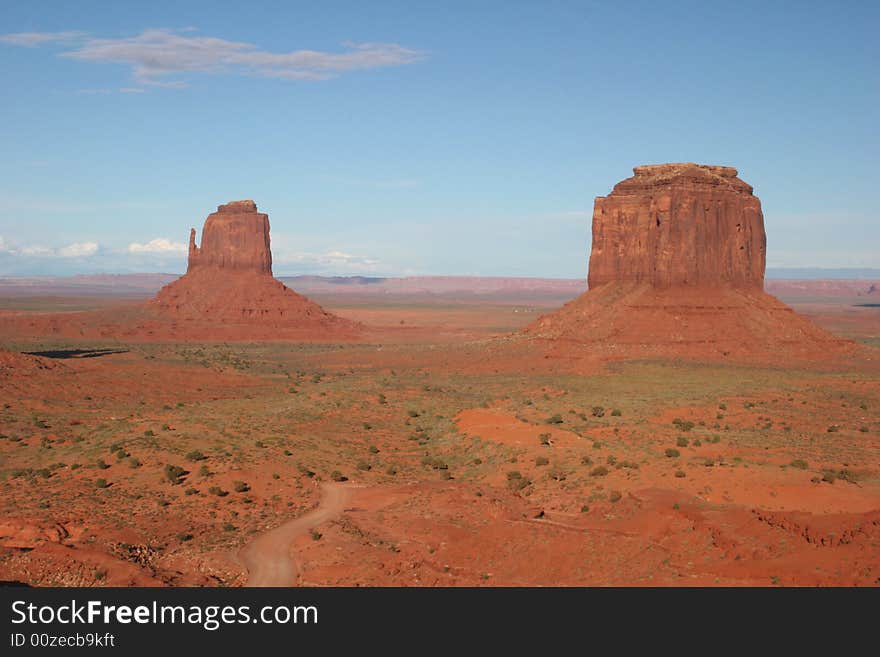 Shot of famous rocks in Monument Valley and the road which makes a loop-tour through the Park. Arizona. USA