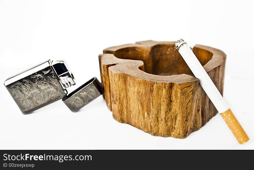 Lighter, ashtrays and cigarette on a white background. Lighter, ashtrays and cigarette on a white background