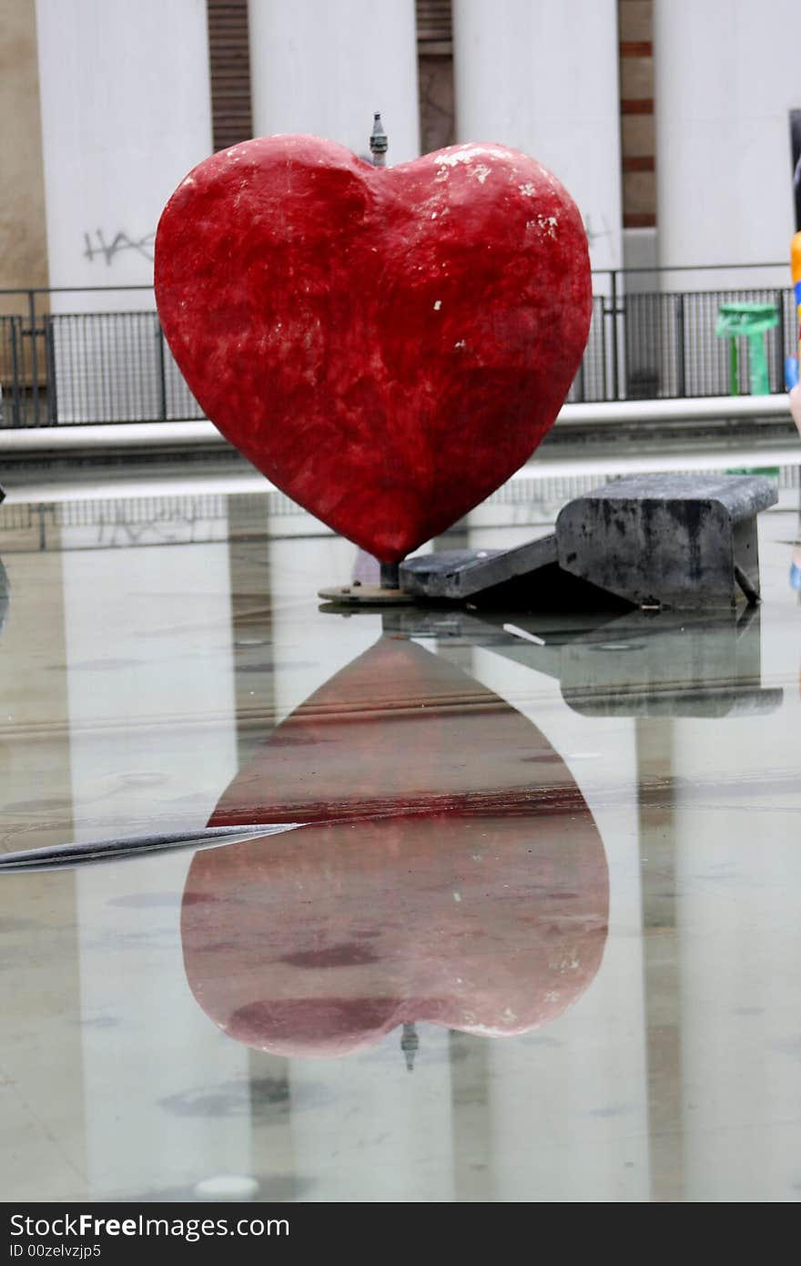 Heart and its reflection in the water in Paris, France.