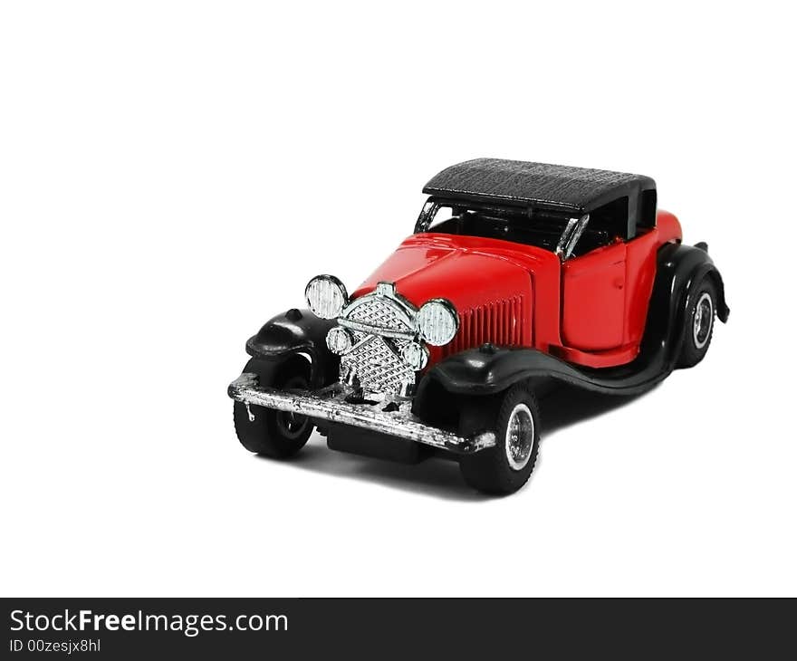 A isolated red and classic toy car. A isolated red and classic toy car.