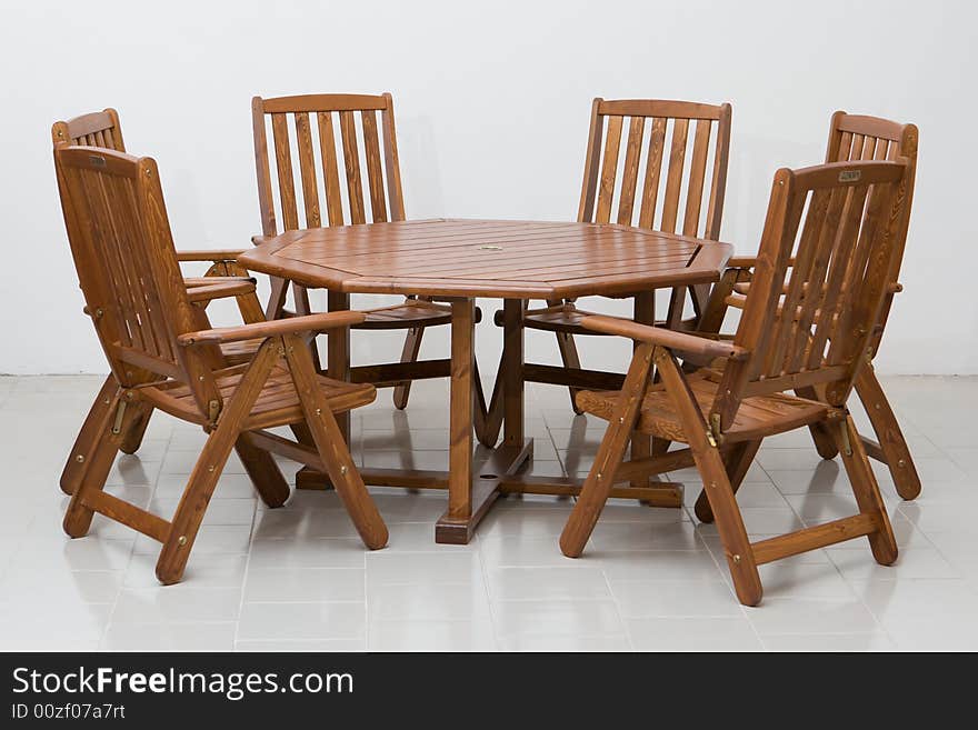 Wooden table and chairs on a tiled floor