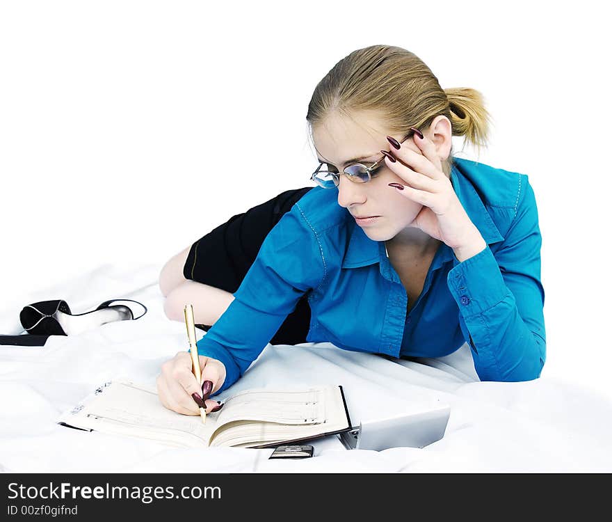 Young businesswoman working - thinking and writing in the notebook