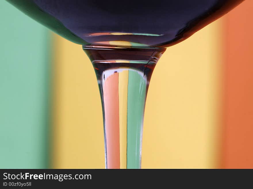 A glass with a simple  green - yellow - orange  color background. A glass with a simple  green - yellow - orange  color background