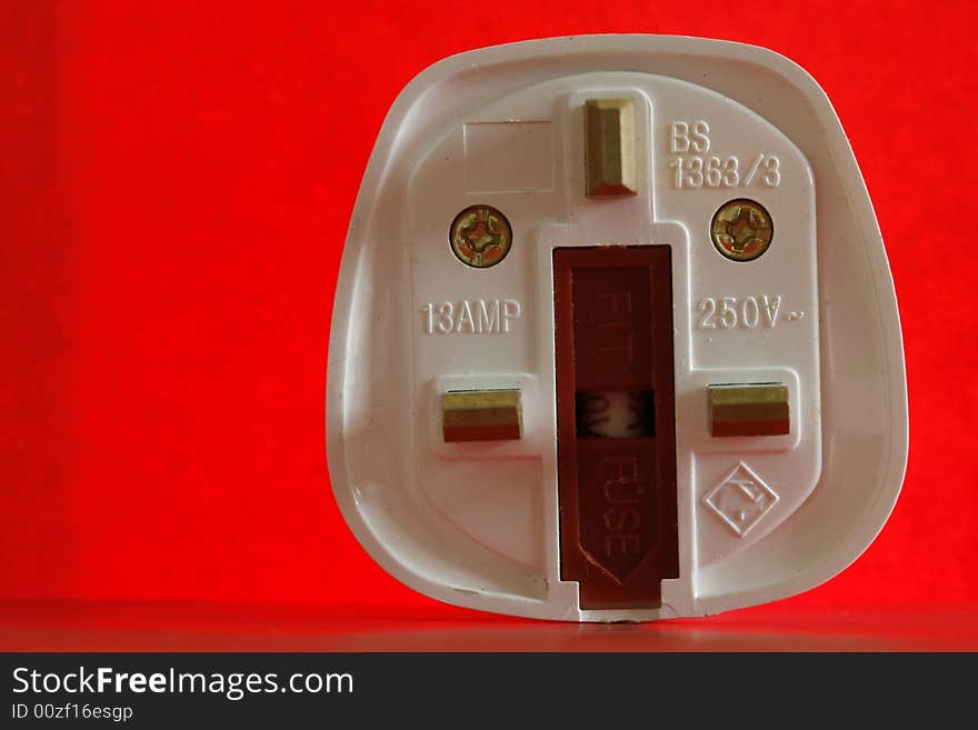 An  electricity fuse in a simple red background. An  electricity fuse in a simple red background