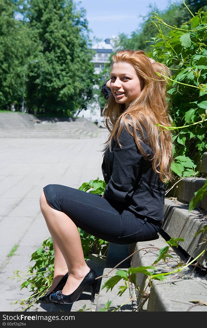 The girl in city park on steps