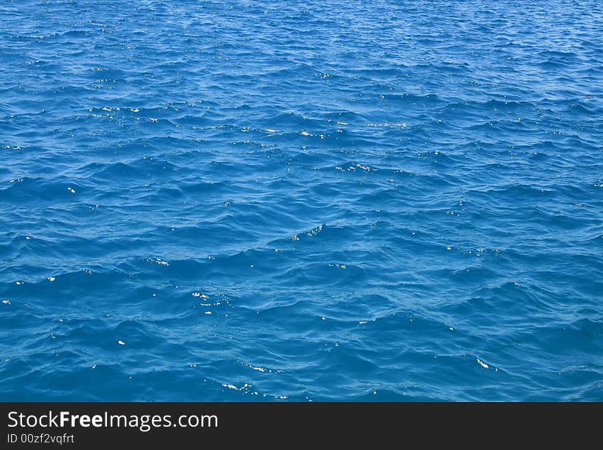 Water waves in the blue sea. Water waves in the blue sea