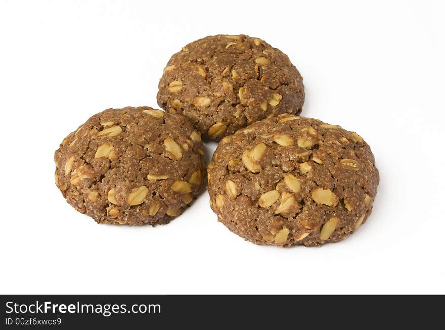 Three delicious cocoa cookie with oat-flakes isolated on white background