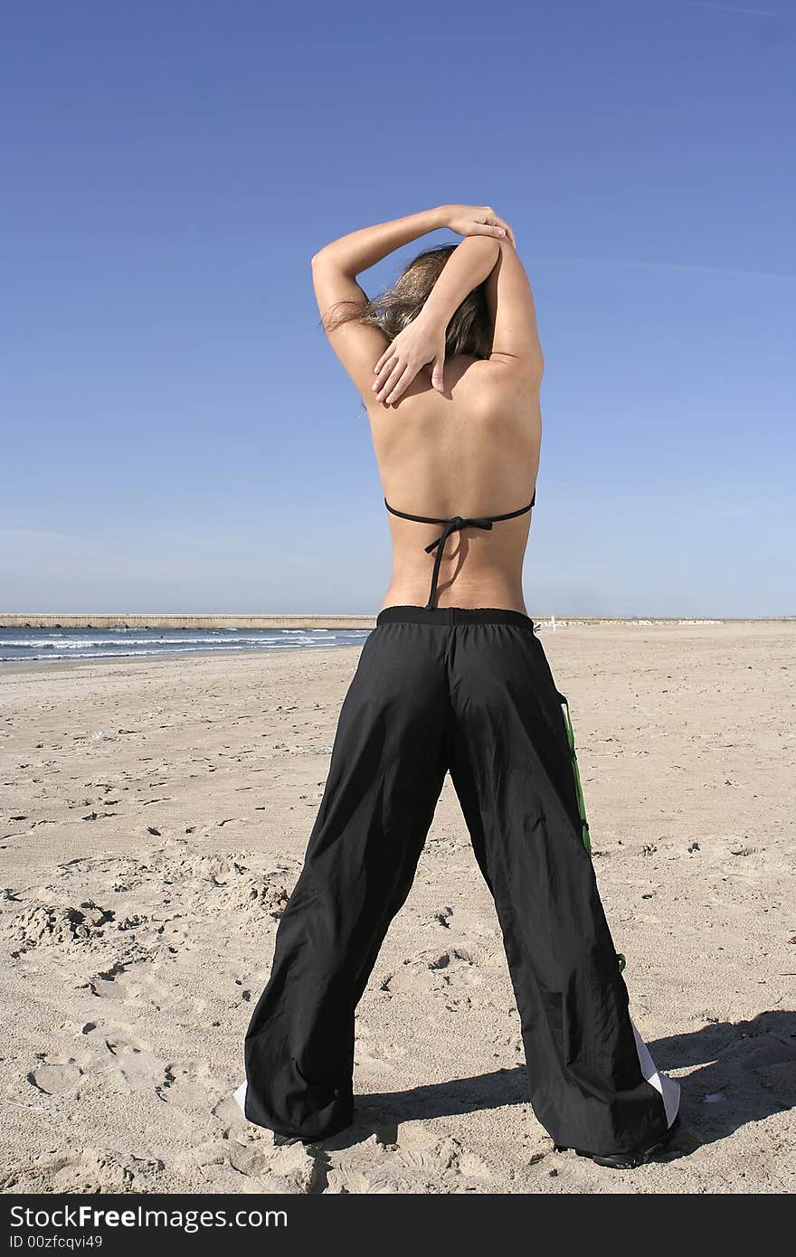 Woman stretching at the beach