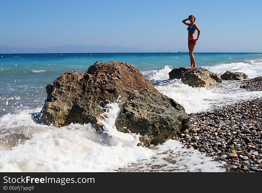 Women standing in the sea on rocks. Women standing in the sea on rocks