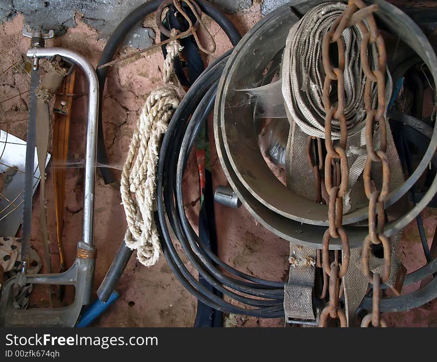 Very old tools hang on a wall