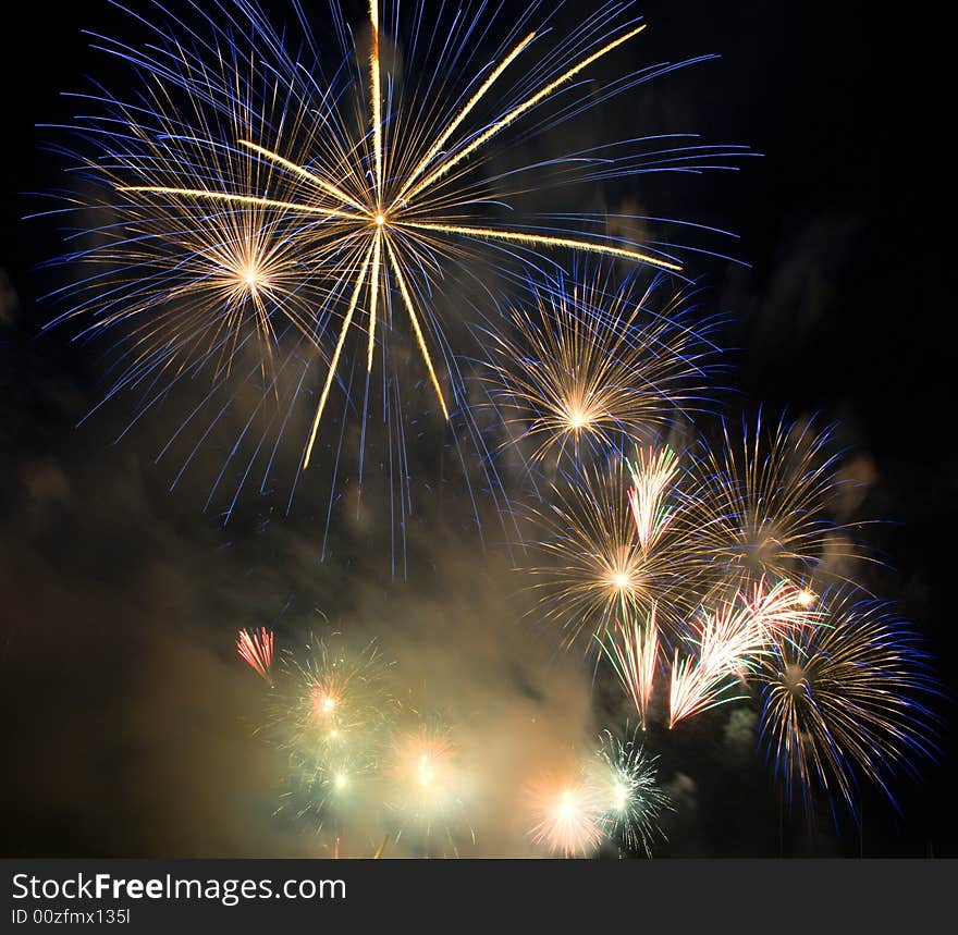 Vibrant colored fireworks and clouds of smoke