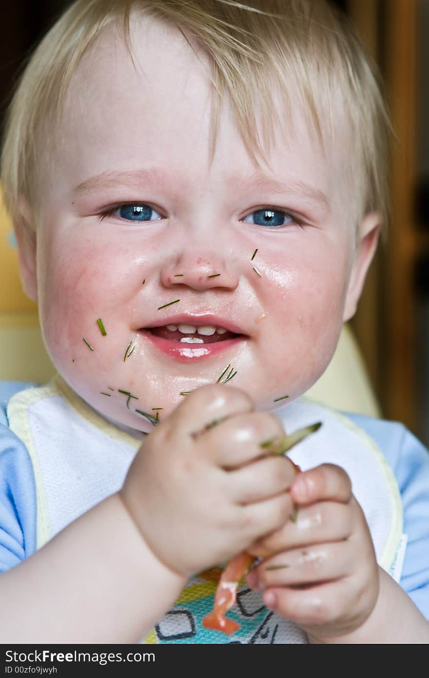 Laughing child soiled with salad