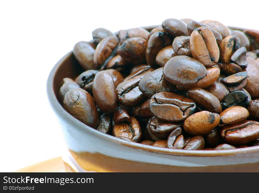 Brown coffee beans isolated on the white background