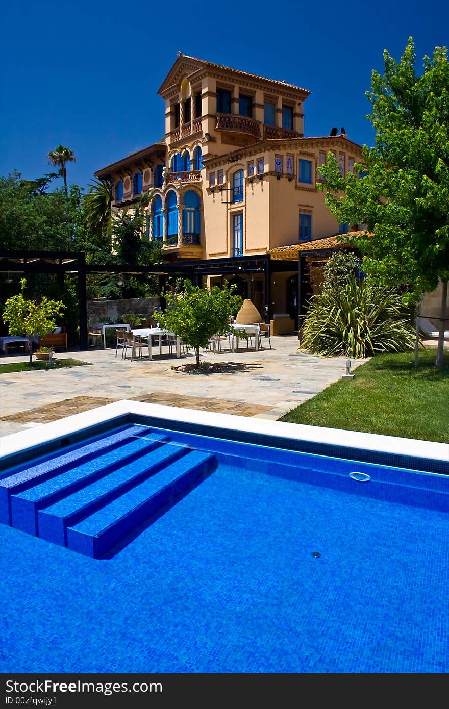 Swimming-pool and an old-fashioned hotel. Swimming-pool and an old-fashioned hotel