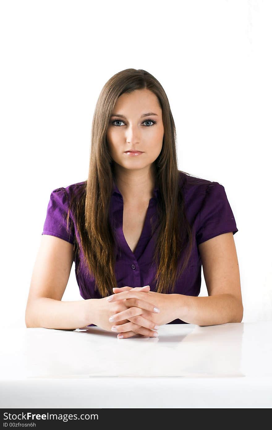 Young beautiful businesswoman on a white table against white background. Young beautiful businesswoman on a white table against white background