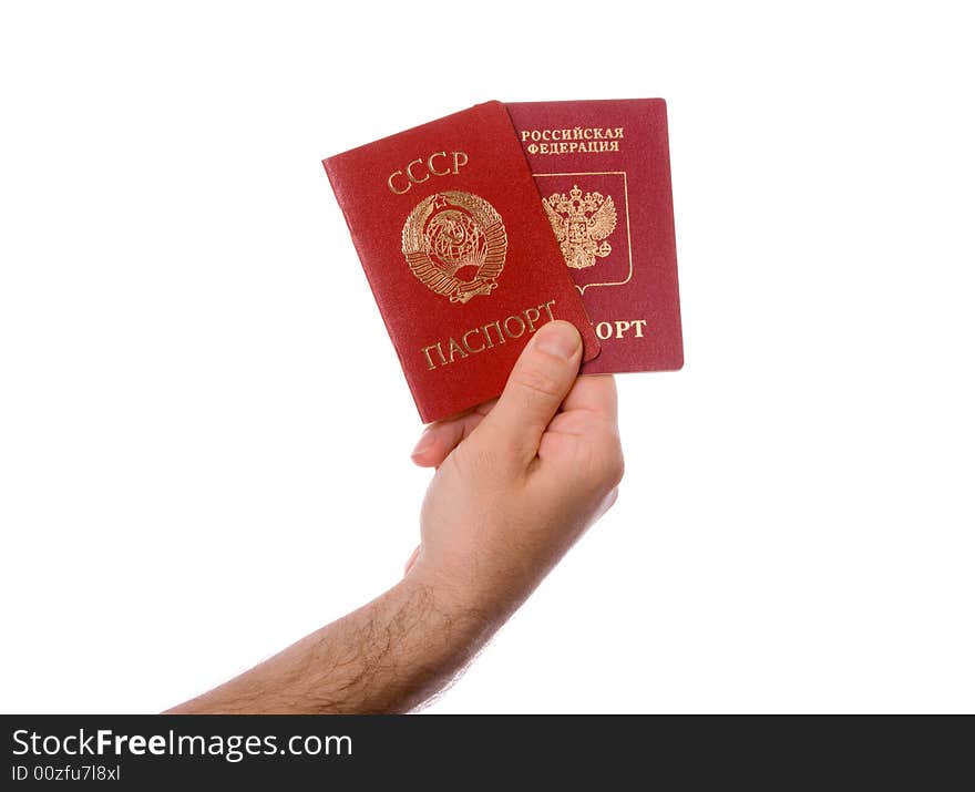 Soviet Union (USSR) passport and Russian Federation passport in the right hand. Isolated on white. Soviet Union (USSR) passport and Russian Federation passport in the right hand. Isolated on white