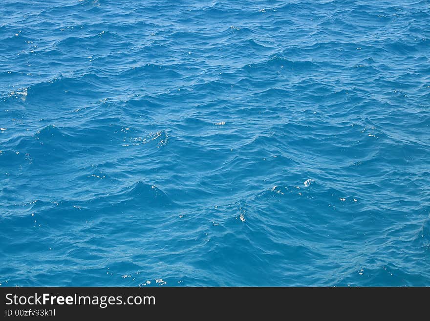 Water waves in the blue sea. Water waves in the blue sea