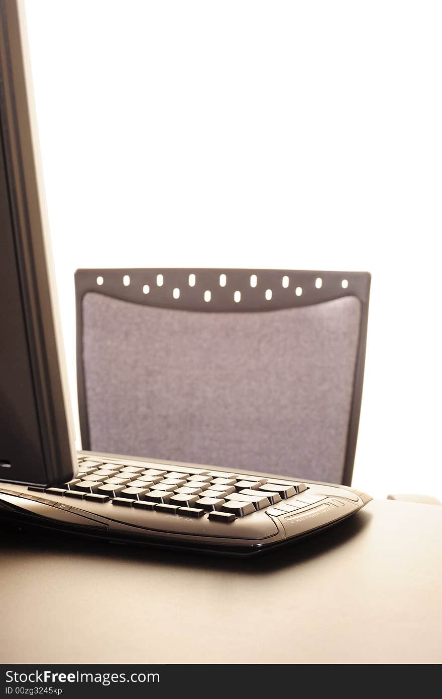 Abstract of a computer keyboard with part of monitor and office chair back, suitable for background image or conceptual design. Abstract of a computer keyboard with part of monitor and office chair back, suitable for background image or conceptual design.