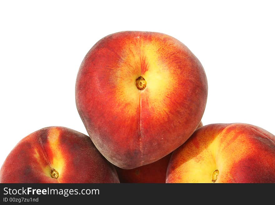 Closeup of three peaches on a white background