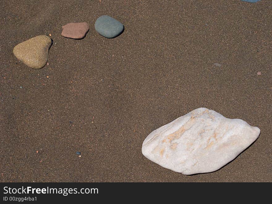 Random river rocks on sandy beach. North Shore Lake Superior. Random river rocks on sandy beach. North Shore Lake Superior