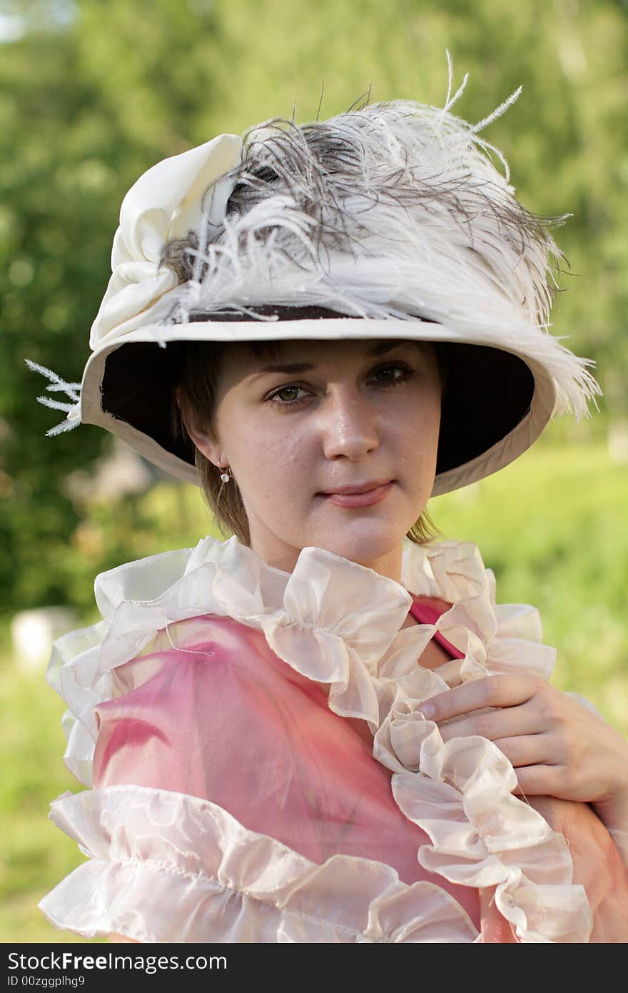 The girl in old-fashioned bonnet in summer. The girl in old-fashioned bonnet in summer