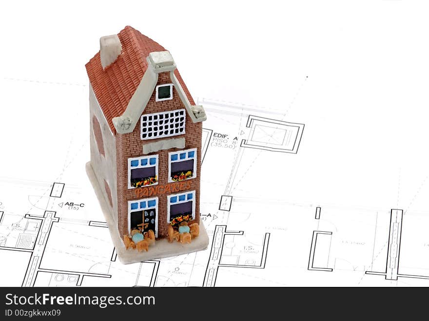 Residential building on top of architect blueprints. Residential building on top of architect blueprints