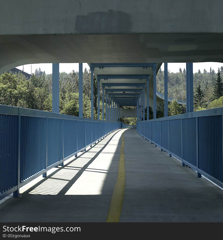 A blue covered pedestrian and cyclist bridge. A blue covered pedestrian and cyclist bridge