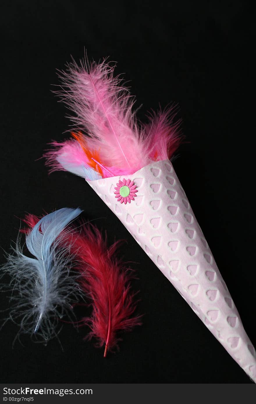 Brightly colored feather confetti in a cone