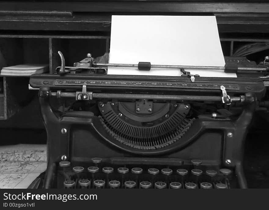 Black and white image of old typewriter and desk