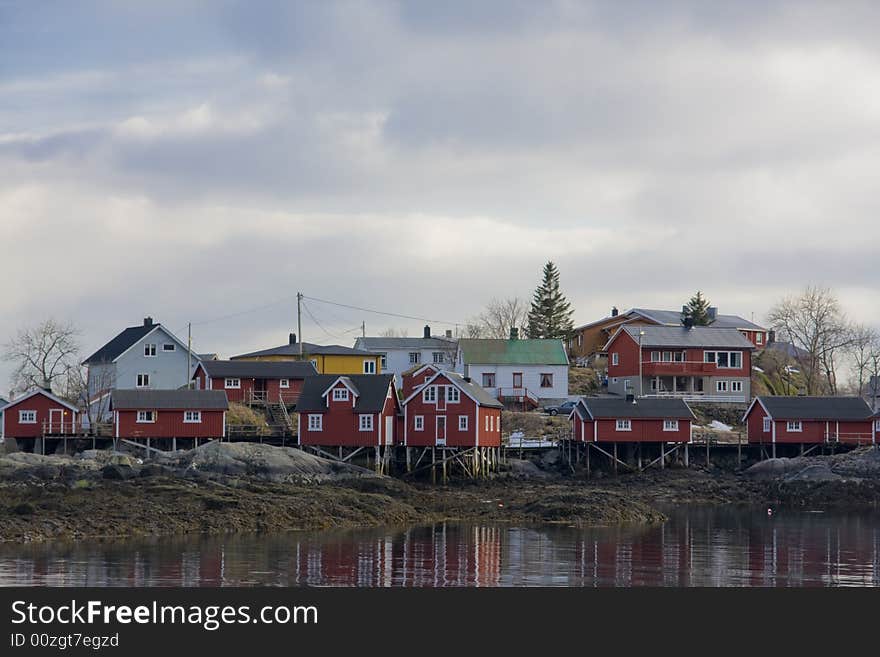 Red houses on stilts at the sea