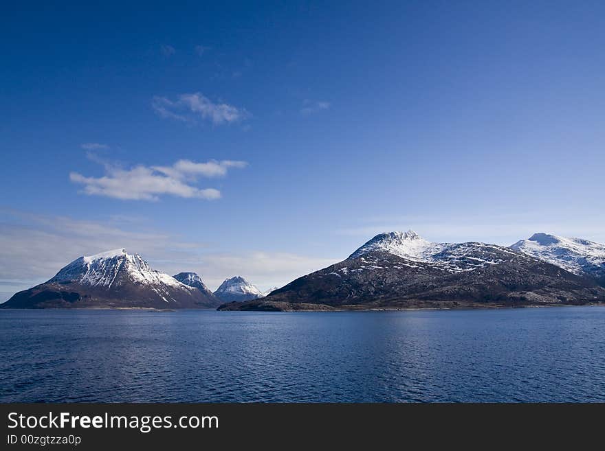 Snow-covered mountains at the Arctic ocean. Snow-covered mountains at the Arctic ocean